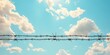 © Levan - A barbed wire fence is set against the backdrop of the sky, with clouds overhead, creating a striking contrast of sharpness against the softness of the sky and clouds.