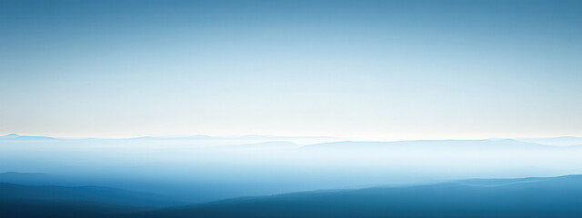 Wall Mural - A blue sky with a few clouds and a mountain range in the background
