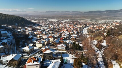 Wall Mural - Aerial view of a snowy town in winter.