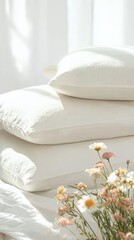 Fototapete - Soft sunlight illuminates a stack of three pristine white pillows on a bed, accompanied by a bouquet of fresh daisies, creating a serene and inviting atmosphere perfect for relaxation and rest