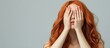 © The 2R Artificiality - Portrait of young girl with vibrant ginger hair covering her eyes against a soft gray background with ample empty space for text or design elements