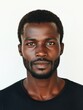 © The 2R Artificiality - Portrait of an African man with a confident expression on a bright white background showcasing ample negative space for text placement.