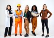 © Syuhuud - Female Jobs. Various women in their work uniforms posing on blue background, diverse happy multiethnic ladies representing different professions standing on white background. Labor day concept.