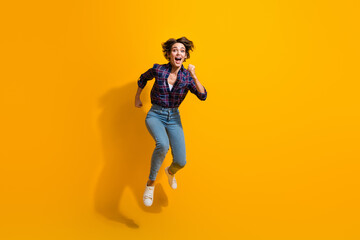 Wall Mural - Full length photo of eccentric crazy woman dressed plaid shirt jeans run shopping on black friday isolated on yellow color background