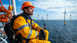 © kongkiat chairat - Offshore technician in safety gear, overlooking wind turbines at sea, feeling focused and determined