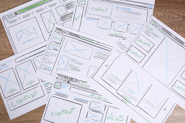 Wall Mural - developing ui design. sketches of website wireframes on wooden table, top view