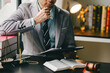 © Suphakant - Male consultant or lawyer working in the office legal concept Advice on justice and the law Male judge in courtroom