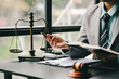 © Suphakant - Male consultant or lawyer working in the office legal concept Advice on justice and the law Male judge in courtroom