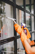 © Suphakant - people doing cleaning are using cloths and spraying disinfectant Wipe the glass in the office room. cleaning staff.cleaning maid