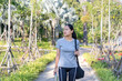 © maemodnit13 - Happy young Asian woman walking on the park walkway Wear exercise clothes Prepare to exercise outdoors. Smiling, looking away Get ready for a morning run on the promenade. Running and jogging concepts