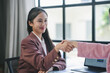 © amnaj - Two businesswomen engaging in a handshake after successfully closing a deal in a professional office setting, highlighting teamwork and collaboration
