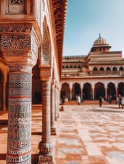 Ornate columns and intricate tilework in a historical building courtyard, showcasing beautiful architecture and traditional design elements.