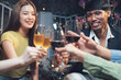 © Kritdanai - Cheers to Friendship: A group of happy friends raise their wine glasses in a celebratory toast, enjoying a night out together.