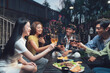 © Kritdanai - Nighttime Backyard Gathering: Friends Toast to Friendship