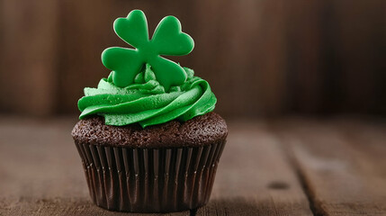 Wall Mural - A delicious chocolate cupcake topped with vibrant green frosting and a festive shamrock decoration, perfect for St. Patrick's Day celebrations.