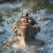 © Fotograf - A dog refreshing itself by splashing water on its face
