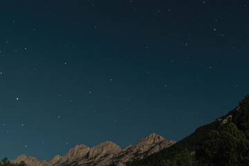 Wall Mural - A view of a mountain under a starry night sky
