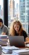 © Ora - Woman working laptop, city view, office, paperwork