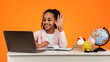 © Prostock-studio - Remote Learning Concept. Portrait of positive African American schoolgirl sitting at desk, making video call using laptop computer. Smiling young black girl waving hand while having virtual class