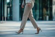 © Fotograf - A woman walking down a sidewalk wearing high heels, great for fashion or lifestyle images
