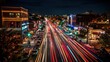 © Darminah - Nighttime view of a busy street with streaking car lights and illuminated buildings.