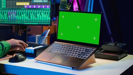 Fototapete - Music producer mixing and mastering songs on digital post production pc interface, green screen display. Artist adding sound effects and adjusting volume levels to produce new music. Camera A.