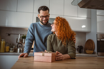 happy delight couple boyfriend and girlfriend open gift together