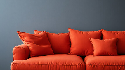 Wall Mural - Orange sofa with cushions against gray wall