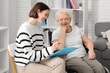 © Pixel-Shot - Young nurse with clipboard and grandmother in wheelchair at home