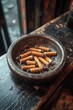 © Ali - Stone ashtray filled with smoking cigarettes.