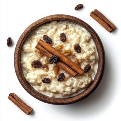 Wall Mural - Creamy Rice Pudding with Cinnamon Sticks and Raisins in a Wooden Bowl on a White Background