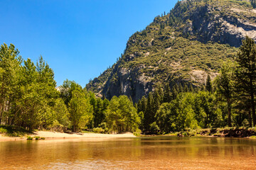 Wall Mural - A mountain range with a river running through it