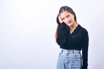 Wall Mural - A young Asian Woman in a Black Velvet Top and Denim Jeans making expressive gestures Isolated on white background