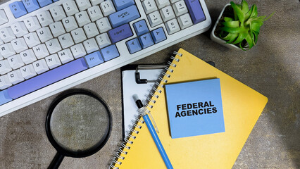 Wall Mural - Concept of Federal Agencies write on sticky notes isolated on Wooden Table.