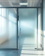 © Boontharika - Modern glass door and wall with frosted privacy design in a bright office space.