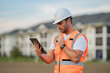© Volodymyr - Engineer with tablet, building inspection. Builder at building site. Construction manager or engineer in helmet outdoor. Male construction engineer. Architect or engineer at a construction site.