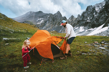 Wall Mural - family travel camping in mountains - father and child setting up tent camping gear, dad and kid hiki