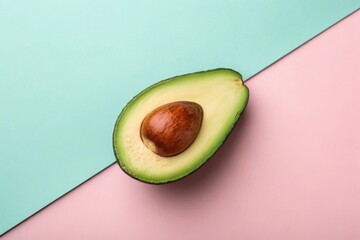 Perfectly ripe avocado half displayed on pastel colored background for minimalist aesthetic