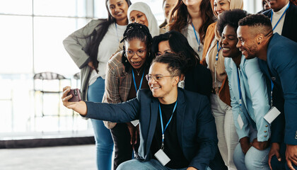 Wall Mural - business people taking a cheerful selfie after a workshop to celebrate collaboration and teamwork in