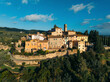 © AmazingAerialAgency - Aerial view of picturesque old town with charming stone buildings and lush greenery, Greve in Chianti, Italy.