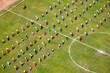 © AmazingAerialAgency - Aerial view of a vibrant community sports event with people engaging in outdoor activities on a lush green field, Side, Turkey.