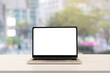 © chinnarach - close up blank white screen display of laptop computer on table in office building with city scene for add content of design banner , website or template or online shopping e-commerce concept
