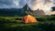 © Engineer - A bright tent placed in the middle of an expansive, protected natural area, with lush green meadows and towering mountain peaks in the distance.