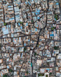 © AmazingAerialAgency - Aerial view of vibrant rooftops and dense buildings in a historic neighborhood, Jaisalmer, India.
