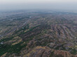 © AmazingAerialAgency - Aerial view of vast arid landscape with rocky hills and barren valley, Jodhpur, India.