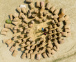 © AmazingAerialAgency - Aerial view of agricultural field with sacks and people working in a circular pattern, Kastail, Austagram, Bangladesh.