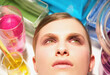 © fStop - Close up of a young woman face surrounded by chemical glassware