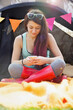 © fStop - Teenage Girl Sitting Outside Tent Using Cell Phone