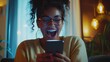 © Akmalism - Excited happy woman looking at phone screen, celebrating online win, overjoyed young female screaming with joy, holding smartphone, reading good news in unexpected message or email.