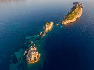 Wall Mural - Aerial view of a chain of small islands in a deep blue sea.